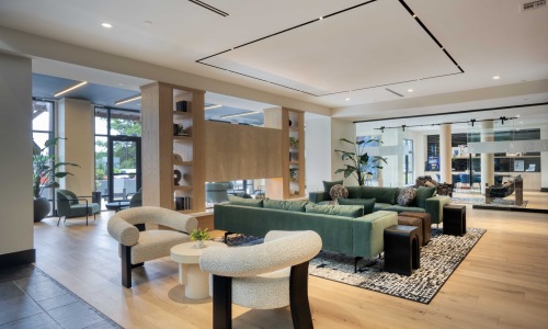 Resident lounge with seating next to multiple conference rooms