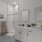 Primary Bathroom with Double Sink Vanity, Tiled Flooring and white walls