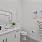 Furnished bathroom with white walls, sinks and a large vanity mirror